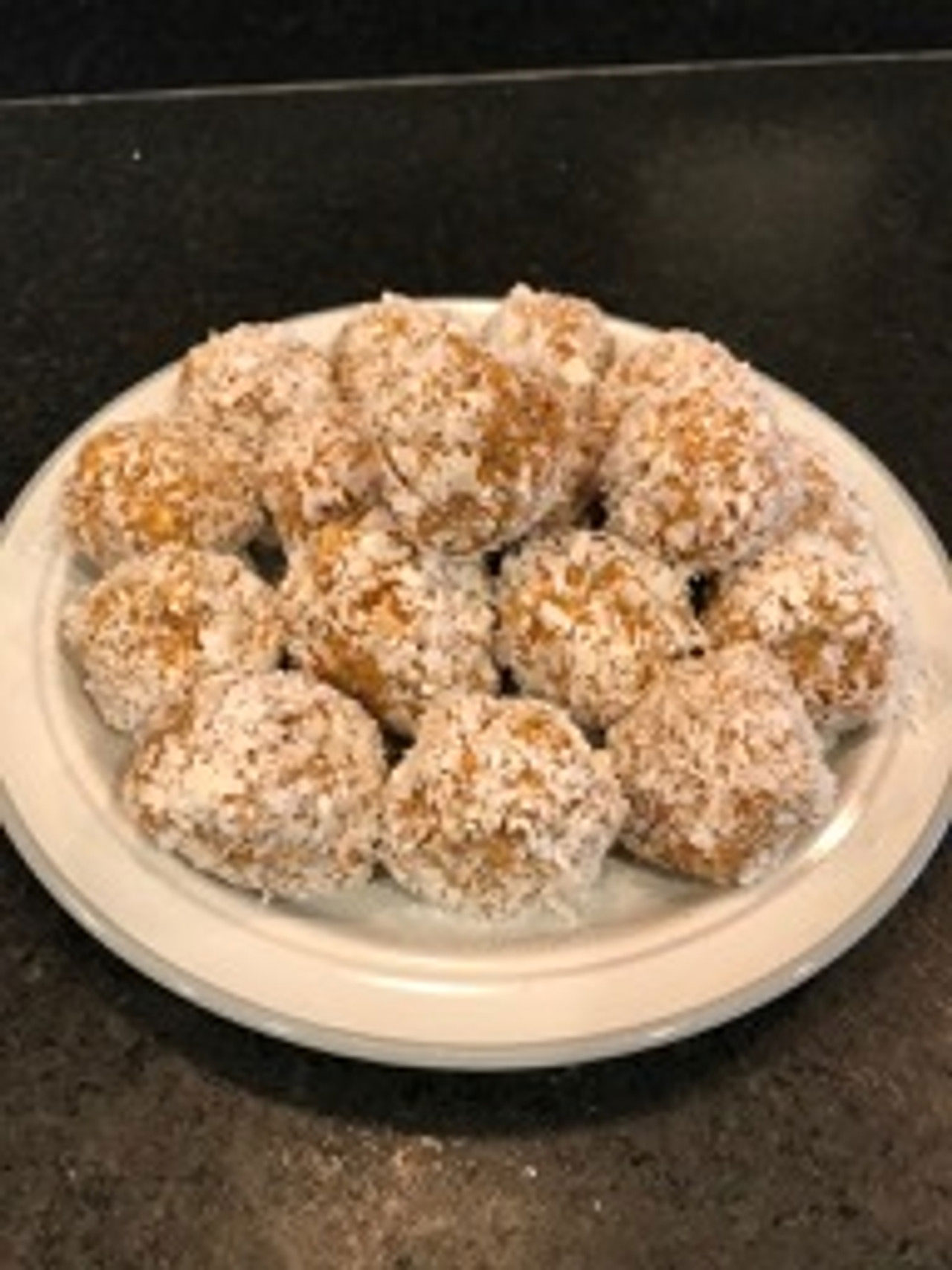 A plate stacked with no-bake Tosteds energy balls.