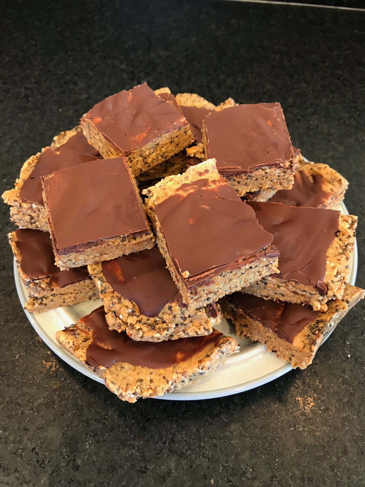 A white plate stacked high with Tosteds homemade protein bars