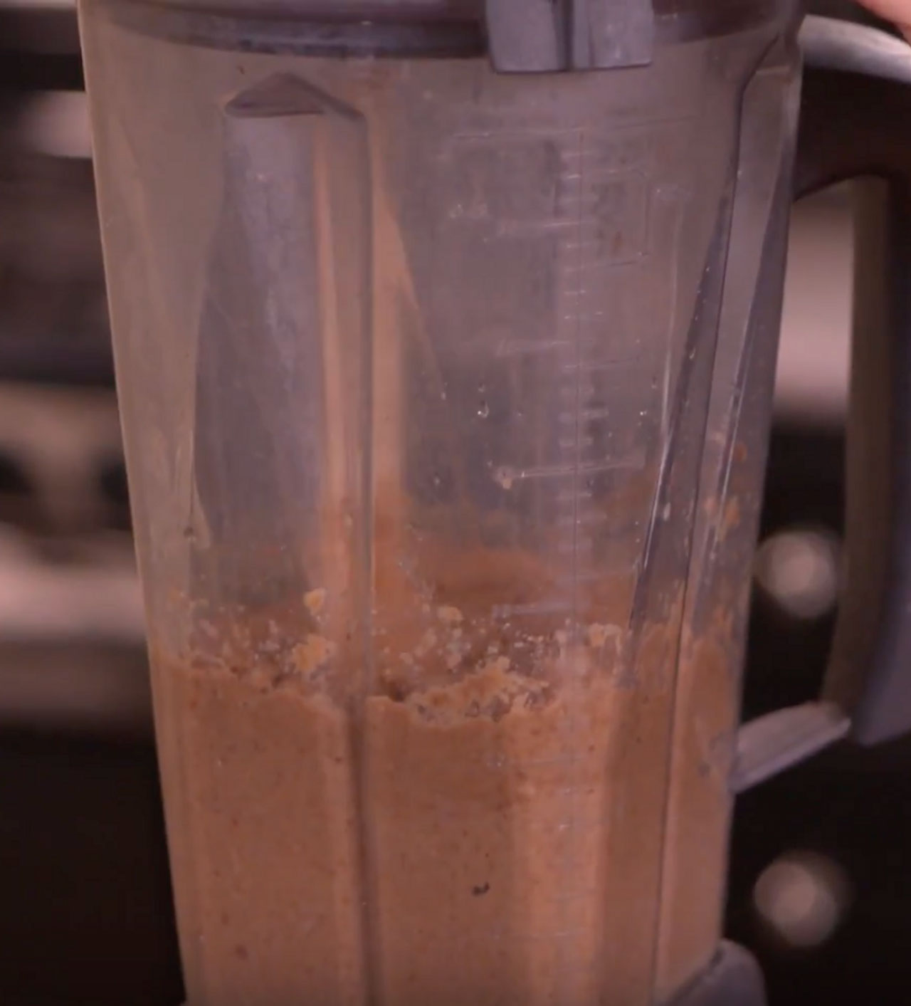 A blender showing a pink-red smoothie.